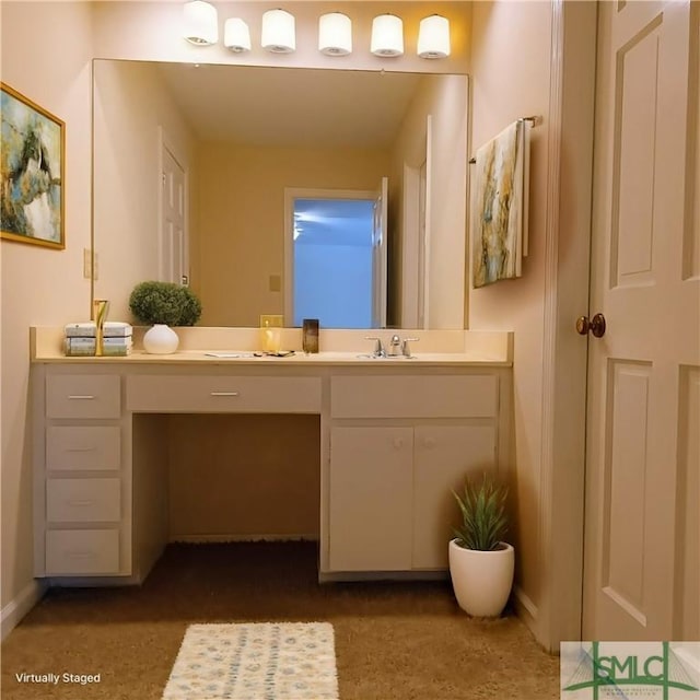 bathroom with vanity and baseboards