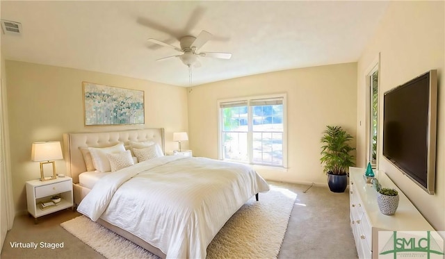 bedroom featuring a ceiling fan, visible vents, and carpet flooring