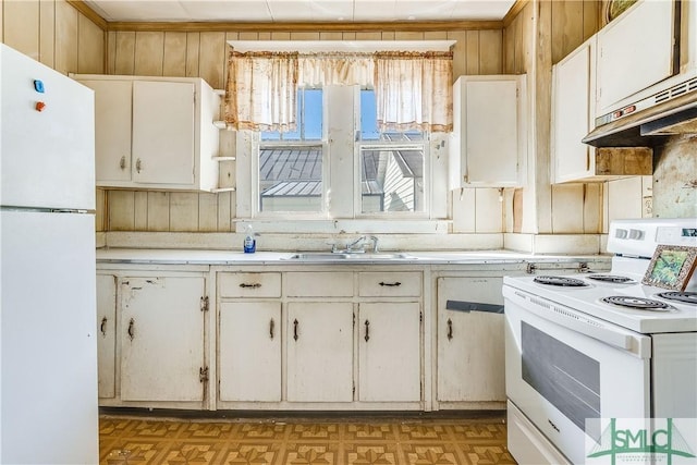 kitchen with light floors, white appliances, a sink, and light countertops