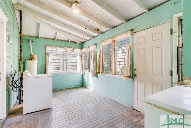 unfurnished sunroom featuring washer / dryer, wood ceiling, water heater, and vaulted ceiling with beams