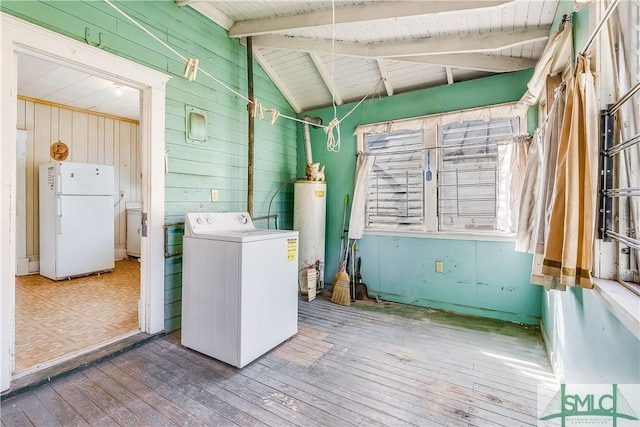 laundry area with wooden walls, laundry area, water heater, washer / clothes dryer, and wood-type flooring