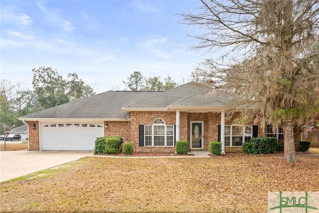 view of front of home featuring a garage, roof with shingles, concrete driveway, and brick siding