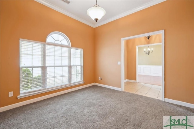 carpeted empty room featuring ornamental molding, a wealth of natural light, baseboards, and tile patterned floors