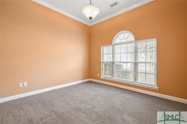 carpeted spare room with baseboards, visible vents, and ornamental molding