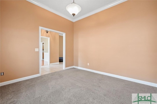 spare room featuring light carpet, crown molding, baseboards, and light tile patterned floors