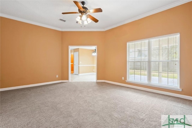 empty room featuring baseboards, carpet, and crown molding