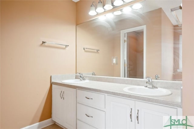 bathroom featuring a sink and double vanity