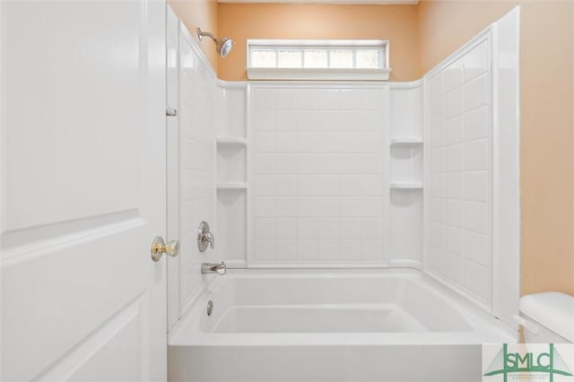 bathroom featuring bathtub / shower combination and toilet