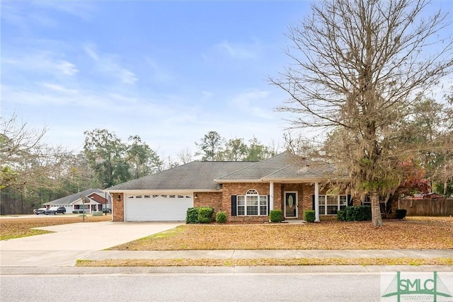 view of front of property featuring a garage, concrete driveway, brick siding, and fence