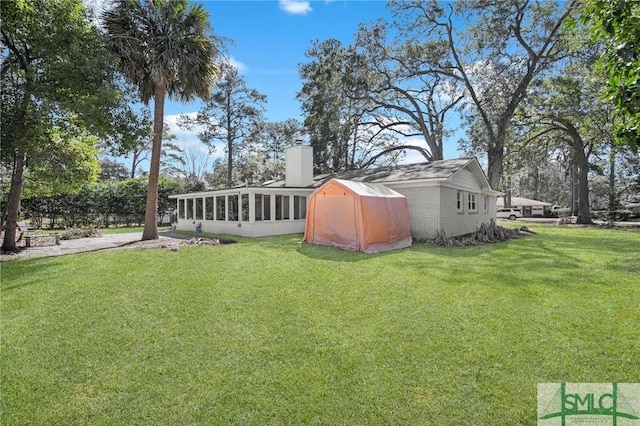 view of yard featuring a sunroom