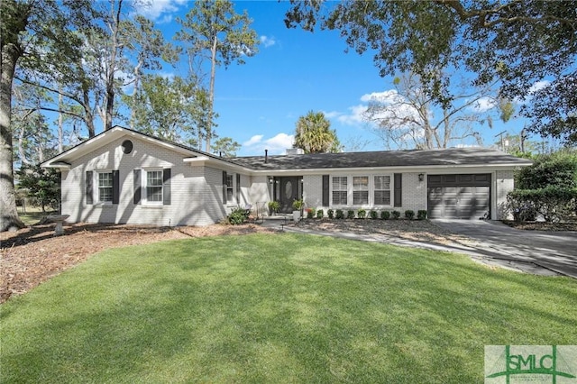 single story home featuring a garage, a front yard, concrete driveway, and brick siding