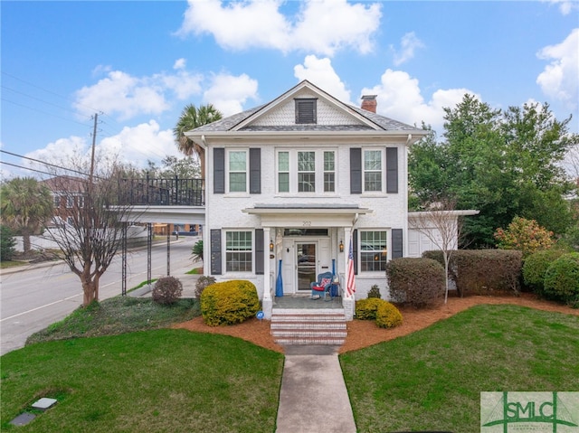 view of front of house featuring a chimney and a front lawn