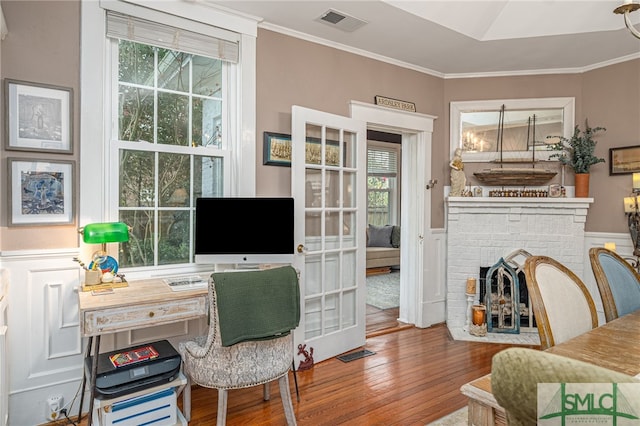 202 E 49th St, Savannah, GA 31405 - office area featuring hardwood / wood-style flooring, plenty of natural light, crown molding, and a brick fireplace