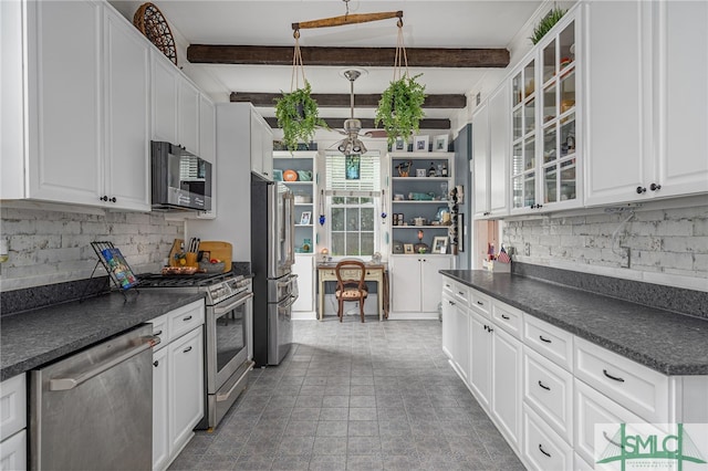 202 E 49th St, Savannah, GA 31405 - kitchen featuring stainless steel appliances, dark countertops, backsplash, white cabinets, and beam ceiling