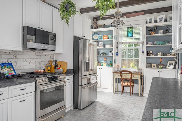 kitchen featuring open shelves, appliances with stainless steel finishes, dark countertops, and white cabinetry