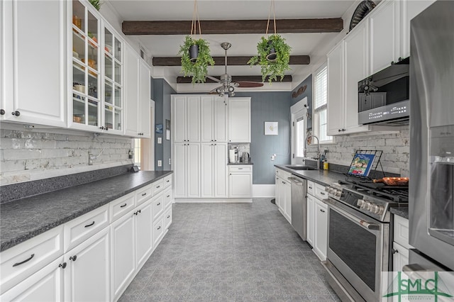 202 E 49th St, Savannah, GA 31405 - kitchen with stainless steel appliances, dark countertops, tasteful backsplash, ceiling fan, and beam ceiling