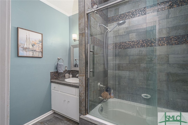 full bathroom featuring ornamental molding, tiled shower / bath combo, vanity, and baseboards