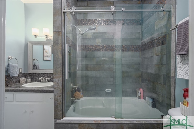 bathroom with tiled shower / bath and vanity