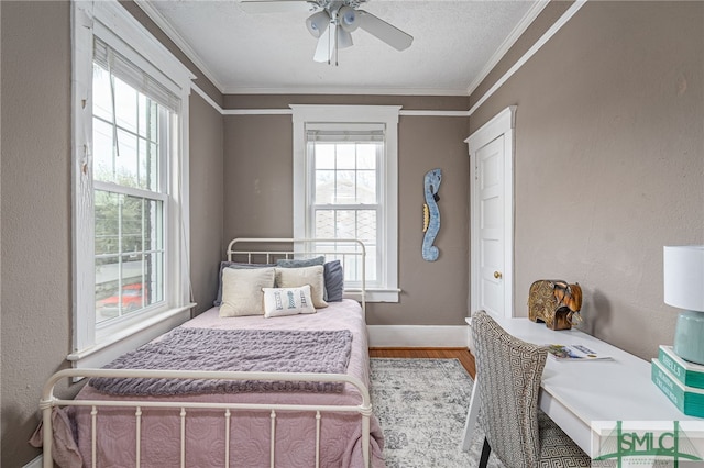 bedroom with baseboards, a textured wall, ornamental molding, wood finished floors, and a textured ceiling