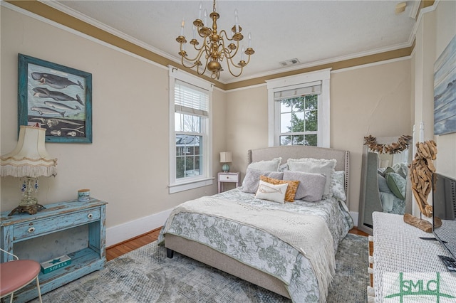 bedroom featuring a chandelier, visible vents, crown molding, and wood finished floors