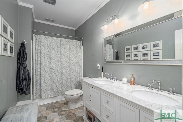 bathroom featuring toilet, ornamental molding, a sink, and visible vents