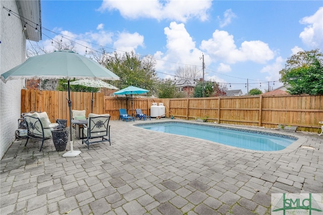 view of pool featuring a patio area, a fenced backyard, and a fenced in pool