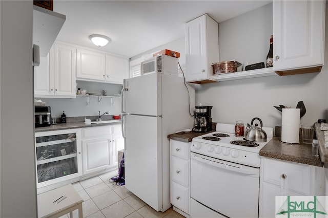 kitchen with open shelves, dark countertops, white cabinets, light tile patterned flooring, and white appliances