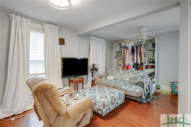 bedroom with a closet, baseboards, and wood finished floors