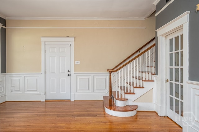 202 E 49th St, Savannah, GA 31405 - entrance foyer with stairs, wainscoting, ornamental molding, wood finished floors, and a decorative wall