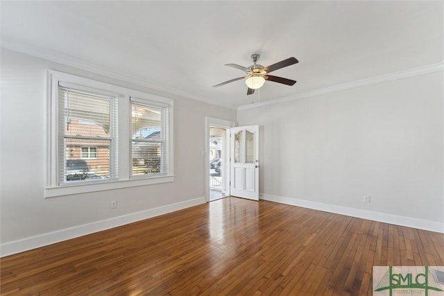 empty room featuring ceiling fan, ornamental molding, hardwood / wood-style flooring, and baseboards