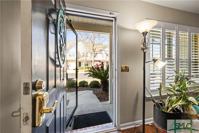 entryway featuring wood finished floors and baseboards