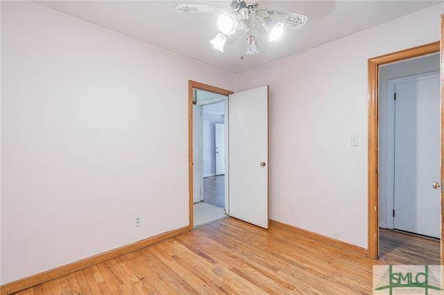 unfurnished bedroom featuring baseboards, a ceiling fan, and light wood-style floors