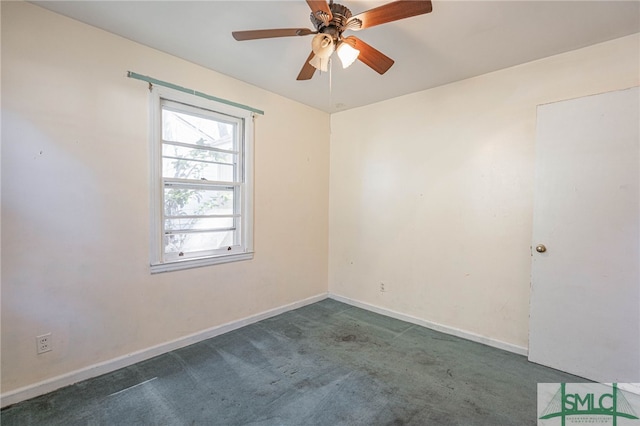 carpeted empty room with a ceiling fan and baseboards