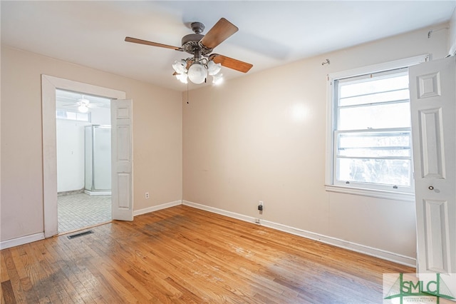 interior space featuring light wood-type flooring, visible vents, and baseboards