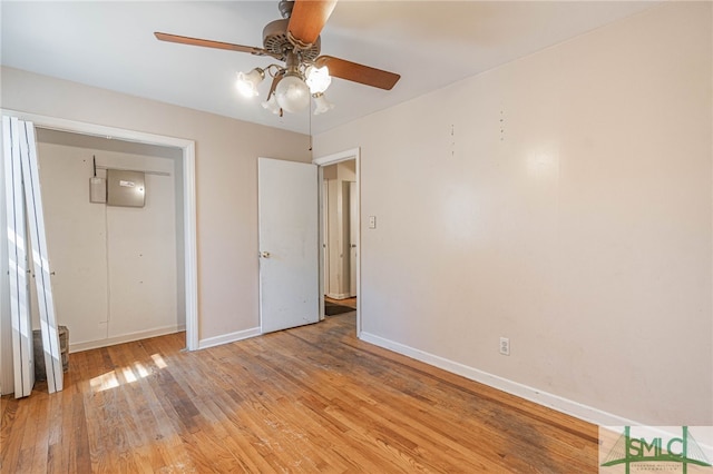 unfurnished bedroom featuring ceiling fan, light wood finished floors, and baseboards