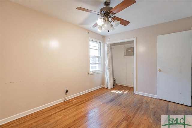 unfurnished bedroom with light wood-type flooring, baseboards, and a ceiling fan