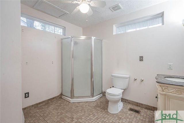 full bathroom with visible vents, toilet, a stall shower, a textured ceiling, and vanity