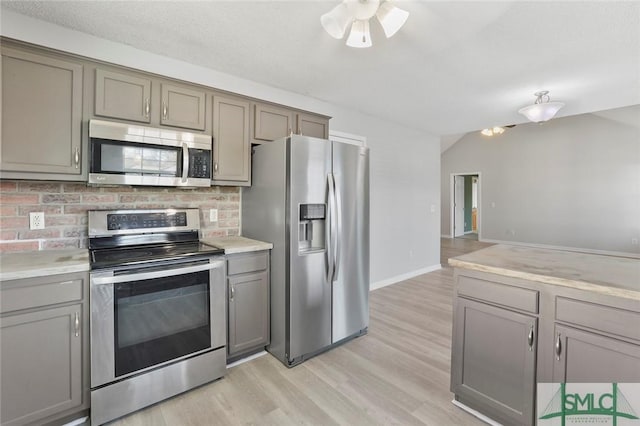 kitchen with light countertops, appliances with stainless steel finishes, and gray cabinetry