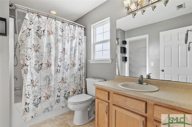 bathroom featuring visible vents, vanity, shower / bath combination with curtain, and toilet