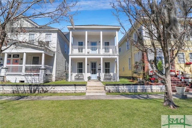 greek revival inspired property with a balcony, a porch, and a front yard