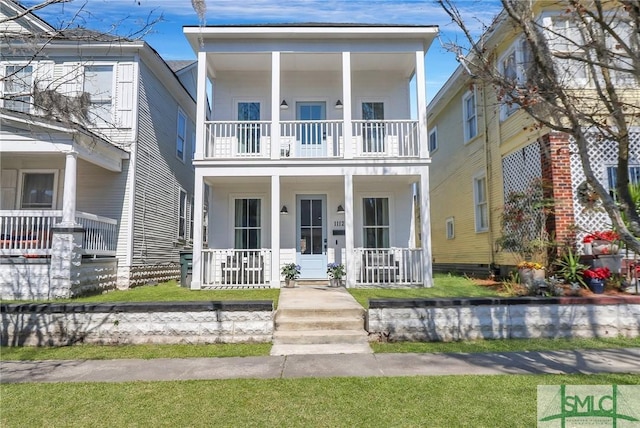 greek revival inspired property featuring a balcony and covered porch