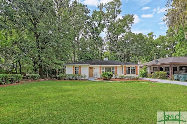 ranch-style house with a front lawn and a chimney