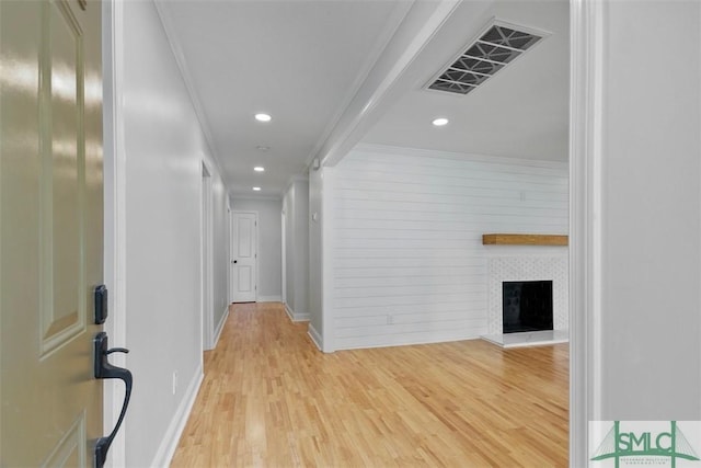 corridor featuring light wood-style floors, visible vents, crown molding, and recessed lighting