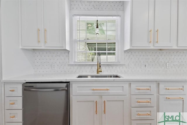 kitchen featuring light countertops, dishwasher, a sink, and white cabinetry