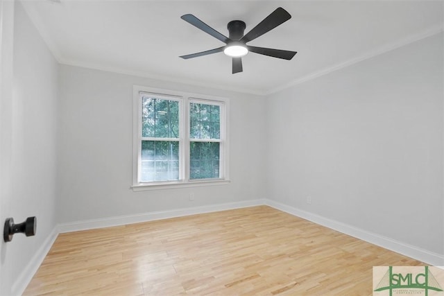 spare room featuring baseboards, crown molding, light wood finished floors, and ceiling fan