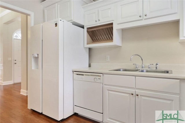 kitchen featuring white appliances, light countertops, a sink, and white cabinetry