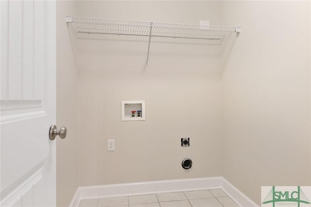 clothes washing area featuring laundry area, hookup for a washing machine, electric dryer hookup, and baseboards