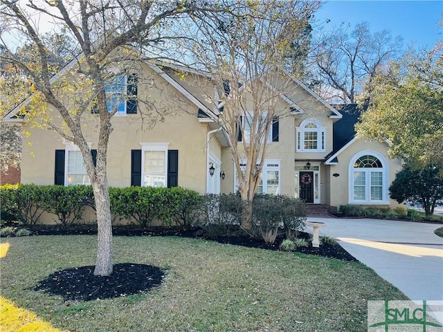 view of front of property featuring a front yard and stucco siding