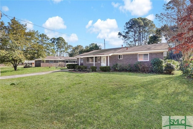 ranch-style house with a front lawn and brick siding