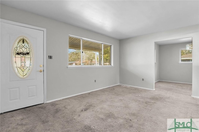 carpeted entryway with baseboards